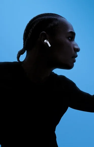 A person talking while wearing AirPods 5